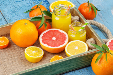 Obraz na płótnie Canvas Different fruits and glass with fresh orange juice