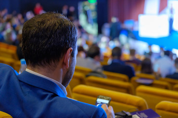 People attend business conference in the congress hall