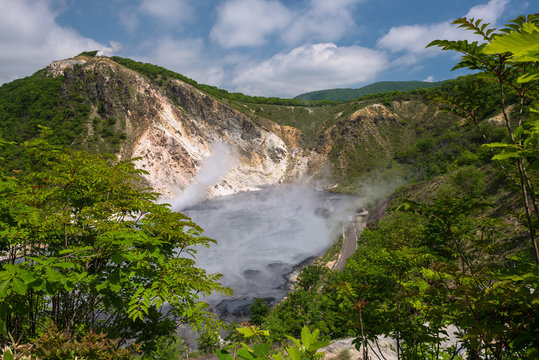 The hot water of Oyunuma pond in the volcanic landscape of Hell Valley (Jigokudani), Noboribetsu, Hokkaido, Japan