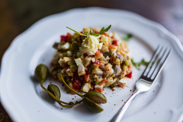 Delicious herring tartar served on a white plate.