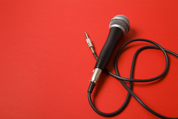 microphone and lead on a bright red background.