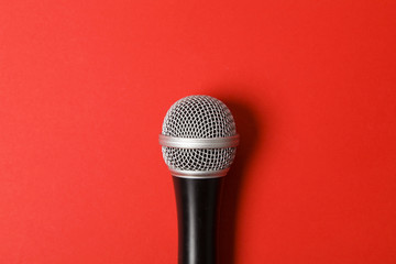 microphone on a bright red background.