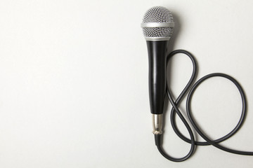 microphone and lead on a plain grey background.