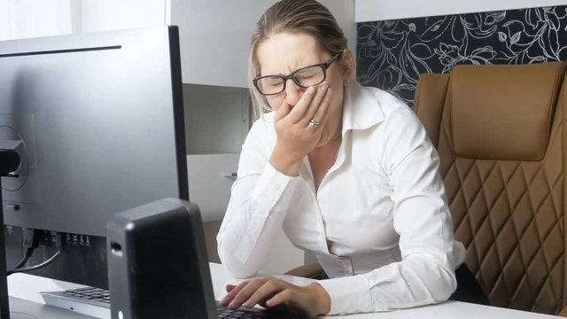4k video of tired hard working businesswoman yawning while working on computer at office