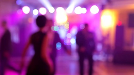 Background of the dance is blurred people dancing in a nightclub.