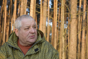 Naklejka na ściany i meble портрет сердитого кавказского старика в лесу 