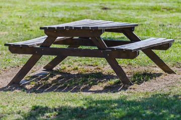 wooden table with benches in the park close-up