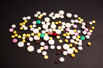 tablets and pills on dark background