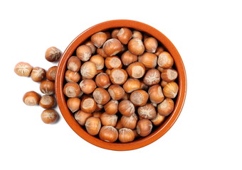 Hazelnuts in bowl isolated on white background, top view