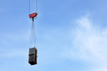 construction of tall buildings/ crane lifts cargo up to the clouds