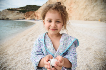 Fototapeta na wymiar Girl Holding Beach Stones in Head