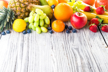 Fresh fruits on wooden background
