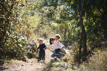 Naklejka na ściany i meble Mother and Children in Forest
