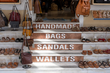 Shoes and bags on the steps of a shop
