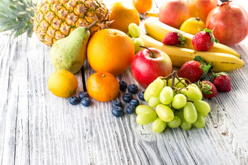 Fresh fruits on wooden background