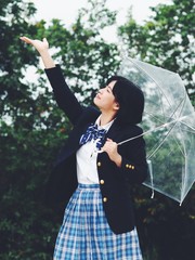 Happy young Asian woman in rainy day.