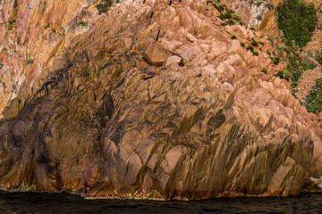 golden rock formations in the marine national park on the island of Corsica