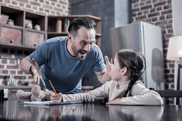 Angry father. Aggressive emotional brutal man looking at his child and shouting at her while being angry