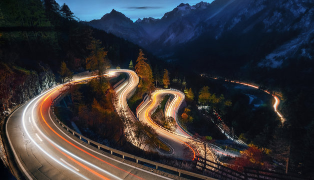 The winding mountain road at the night with light tracks from cars, Maloja Pass, Switzerland