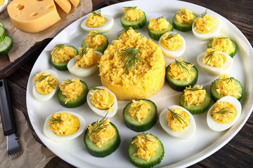 cheese garlic salad on half of eggs and cucumbers