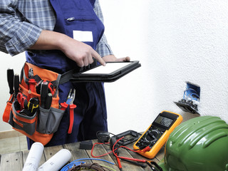 Young electrician working in a residential electrical installation