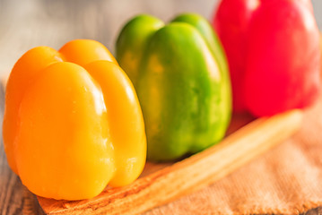 Variety of bell paprika peppers on cutting board