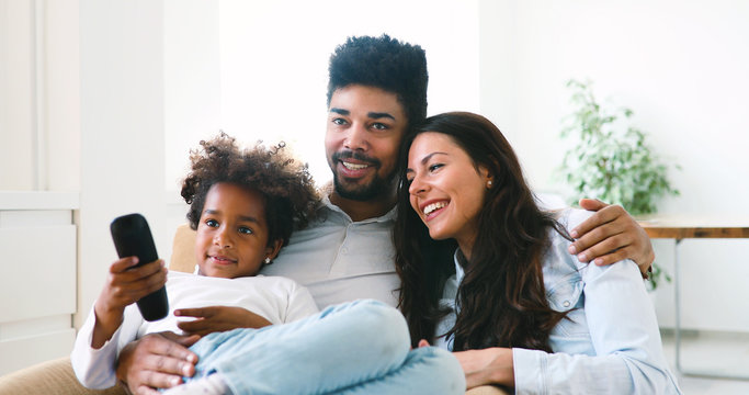 Young Girl Watching Tv With Her Parents