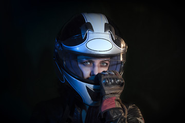 portrait girl dressed with motorcycle jacket while pull out the motorcycle helmet from the head