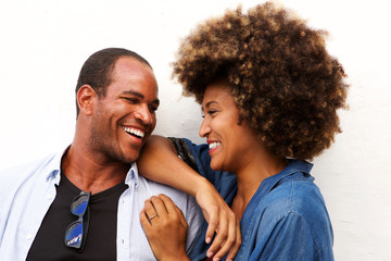 Close up portrait of beautiful couple laughing and standing isolated on white
