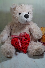 A teddy bear  and heart. Teddy bear as a gift for Valentine. Happy Valentines day - soft focus