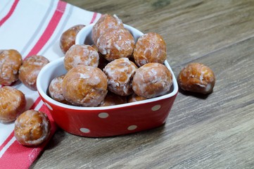 Sweet small donuts in the platter in the shape of a heart. . The fat Thursday of carnival. Slavic tradition
