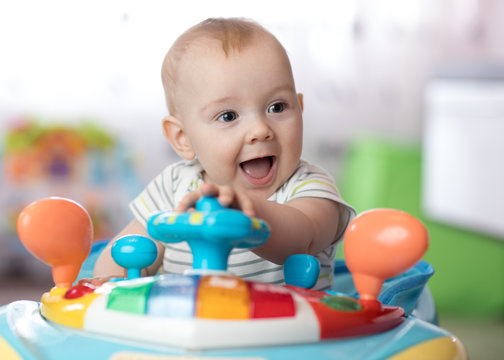 funny baby playing in baby jumper