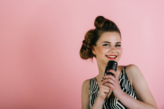 Girl in glasses sing in microphone