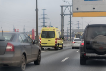 ambulance car among urban car traffic