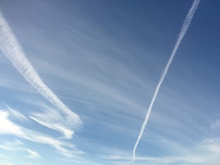 contrails and high clouds in winter sky