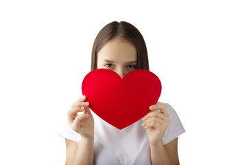 A young girl in a white shirt and red skirt holding a heart