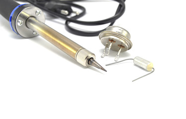 Radio components and electric soldering iron on white background close-up