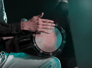 Drum / View of musician playing drum in concert at night. Movement. Soft focus.