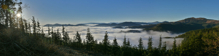 Panoramic of a valley covered with sea of clouds 