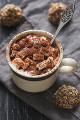 Coffee with marshmallows and candy truffles on a wooden table. selective focus.