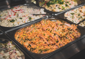 Stand with salads in the diner with self-service.