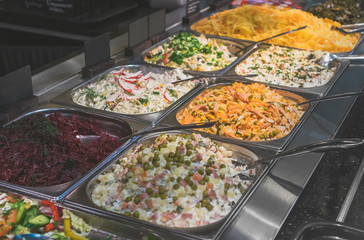 Stand with salads in the diner with self-service.