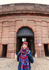 Fototapeta na wymiar Woman traveler with backpack at Leopold Gate in Vysehrad castle in Prague