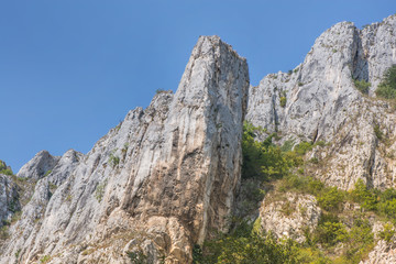 Mountain range with blue sky background in Cheile Turzii, Romania.