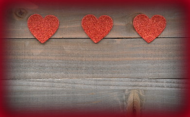 Obraz na płótnie Canvas Red hearts on wood background