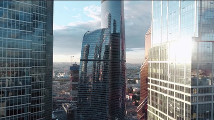 A sun set drone Aerial shot of skyscrapers of  business centre, 4K Ultra HD real time video. Urban scene of financial company office. Camera moving slow forward buildings. Moscow skyline - Powered by Adobe