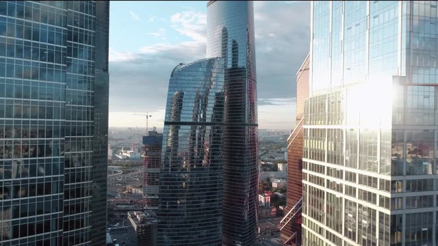 A sun set drone Aerial shot of skyscrapers of  business centre, 4K Ultra HD real time video. Urban scene of financial company office. Camera moving slow forward buildings. Moscow skyline