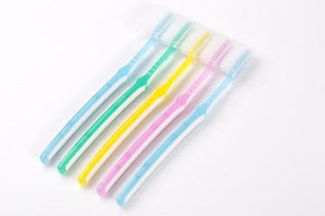 Set of multicolored toothbrushes on white
