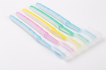 Set of multicolored toothbrushes on white