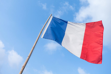 Fototapeta na wymiar France flag of wave with bamboo flag pole and blue sky background